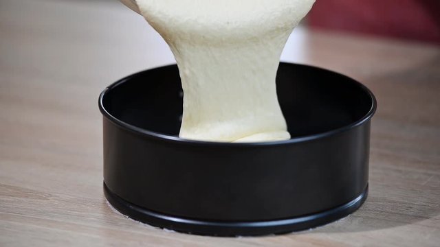Pouring cake mix into baking tin, springform . Making Layer Cake.