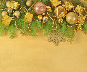 Golden Christmas decorations on a spruce branch