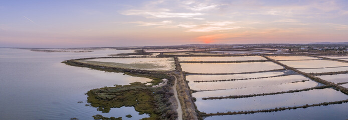 Dusk aerial panoramic seascape view of Olhao salt marsh Inlet, waterfront to Ria Formosa natural park. Algarve.