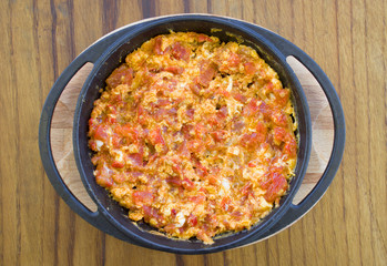 Traditional egg tomato onion menemen cooking for breaskfast serving in istanbul turkey