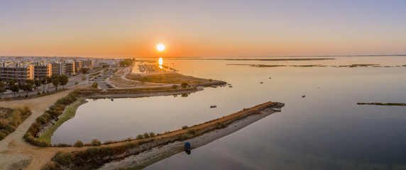 Sunrise aerial seascape view of Olhao salt marsh Inlet, waterfront to Ria Formosa natural park. Algarve.