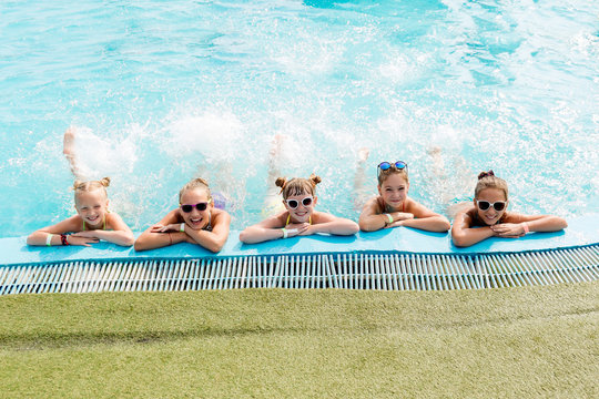 Children rest in the pool in summer