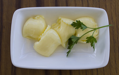 pat of fresh farm butter on a butter dish