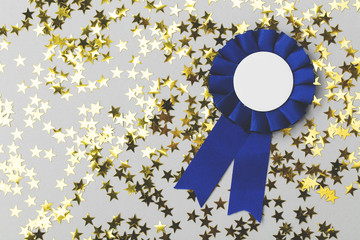 First place award rosette with gold stars. Success achievement concept