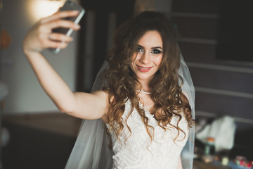 Beautiful bride making selfie in the home before wedding