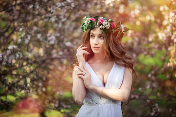 Charming bride in the flowered garden. A spring wedding.