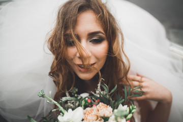 Portrait of a beautiful happy bride with bouquet