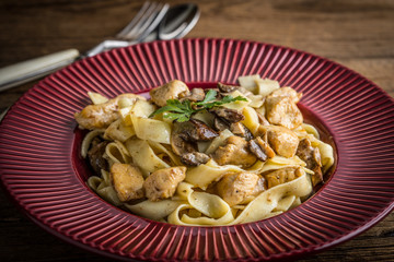 Tagliatelle pasta with forest mushrooms and chicken.