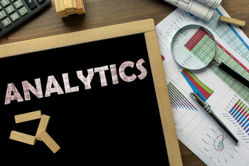 Text Analytics on the blackboard on the desk with office business accessories