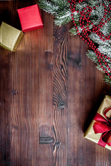 packaging christmas gifts in boxes on wooden background top view