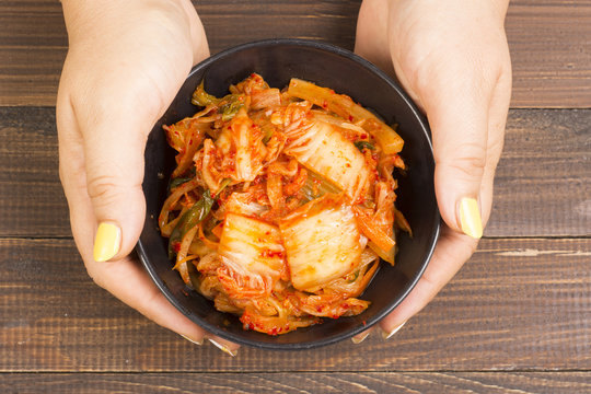 Kimchi or kimchee on black plate