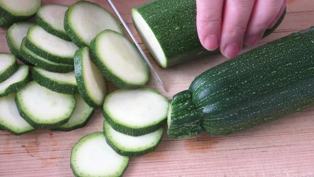 Cut zucchini on chopping board for cooking
