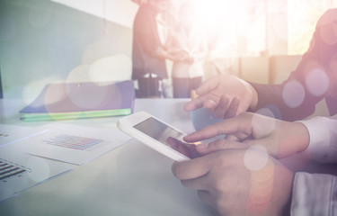 Business team two colleagues discussing financial graph data on office table.