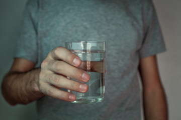 Man hand glass of water