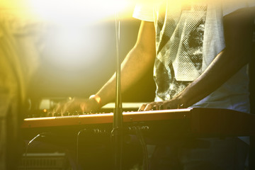 Pianist playing music in a live show. Back light and empty copy space for Editor's text.