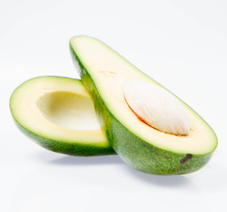 Avocado cut in half on a white background