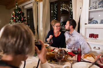 Beautiful couple celebrating Christmas together with the family.