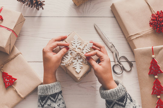 Woman's Hands Wrapping Christmas Holiday Present With Craft Twine