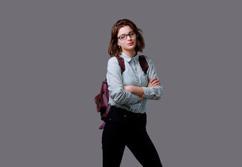 Female with leather backpack isolated on grey background.