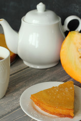 Pumpkin pie on grey wooden desk.