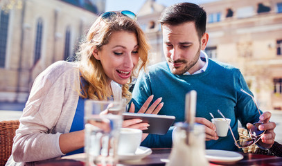 Young couple having fun with tablet. Dating, relationships, love, romance, lifestyle, technology