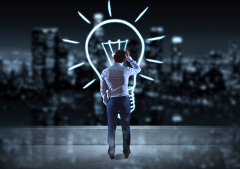 Businessman watching hand drawn lightbulb on a rooftop 3D rendering