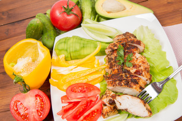 Chicken fillet with vegetable on the side (avocado, tomato, cucumber, bell pepper)
