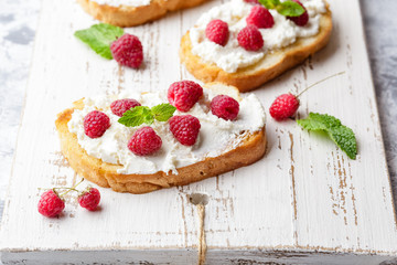 Breakfast slice of bread with Ricotta cheese served with raspberries