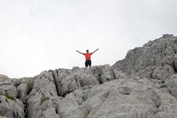 hiker in the high of a rock in Pyrenees, Spain