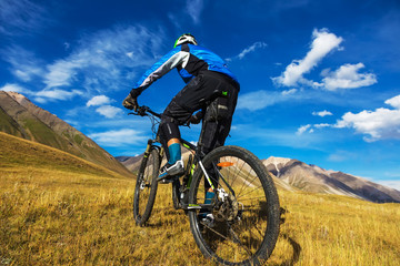 The guy on a bicycle in the mountains. Autumn in the mountains.