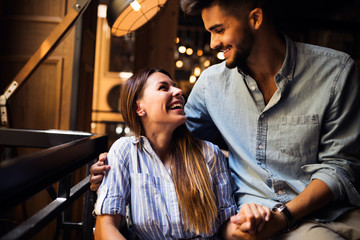 Young attractive couple on date in coffee shop