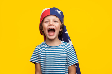 Cheerful kid with flag on head
