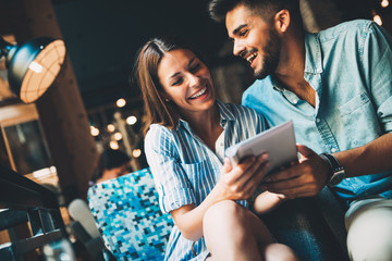 Young attractive couple on date in coffee shop