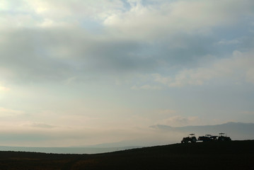 Farmer in tractor preparing land with seedbed cultivator