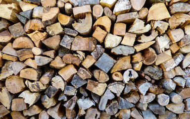 Dry chopped firewood logs piled up