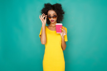 Happy girl drinking coffe at studio background