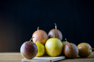 passion fruit on wooden with black background