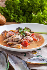Cooked mussels in tomato sauce.