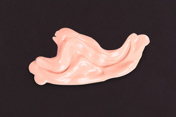 Fototapeta premium Liquid makeup foundations smear drop on black background.