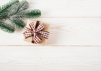 Christmas tree branch with and gift box.New year,Christmas  concept.Wooden background.Top view.