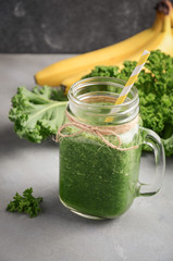 Fresh green smoothie with kale and banana, selective focus.