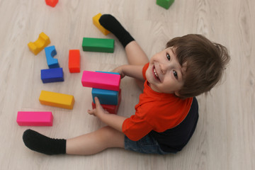 Young kid playing on a floor in a room