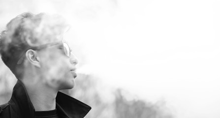 Black White photo of Asian young man outdoors posing