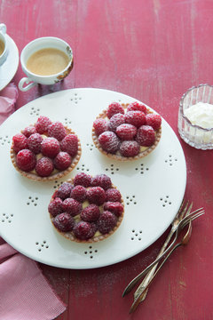 Raspberry tarts on cake stand