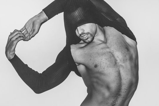 artistic,handsome man with a twisted shirt in motion,fashion ,style