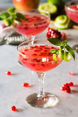 Pink Pomegranate Basil Martini or Cocktail with Fruit and Ingredients on Bar