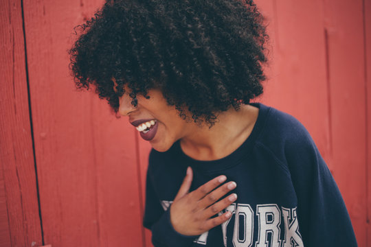 Curly haired woman in sweat shirt crop top