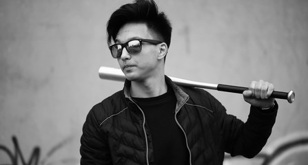 Black White photo of Asian young man outdoors posing