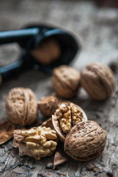 Walnuts and nutcracker on wooden background