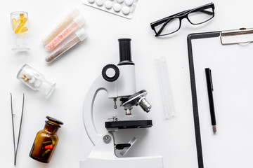 Do medcal tests. Microscope, tablet, pills and test tube on white background top view